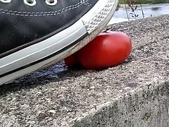 Tomato crushed under All Star Converse sneakers