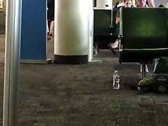 Co Worker Dangling Black Flats in Airport