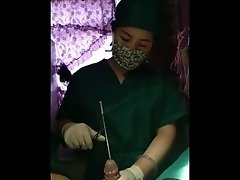 Chinese doctor doing sounding wearing tight surgical gloves